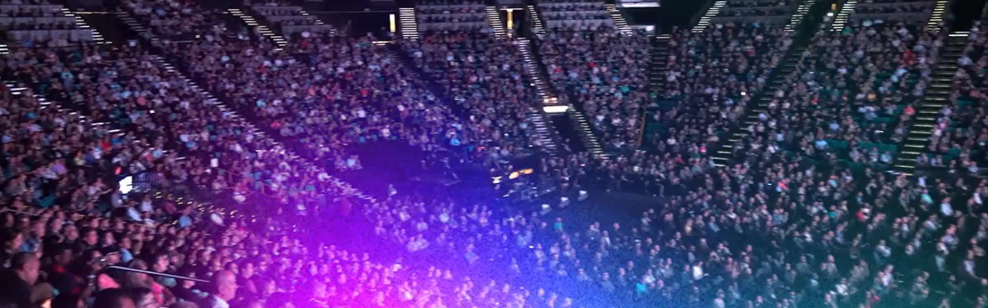 Large crowd watching event in auditorium